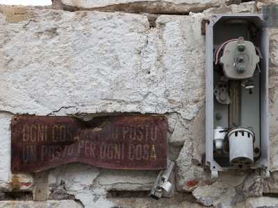 Scarpiniamo sulle sterpaglie del pavimento e osserviamo sui muri alcuni avvisi scritti su targhe arruginite. C'� anche quello che sembra essere uno slogan per i lavoratori: recita "Ogni cosa al suo posto, un posto per ogni cosa"